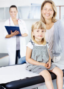 little girl and mother with female family medicine doctor in clinic